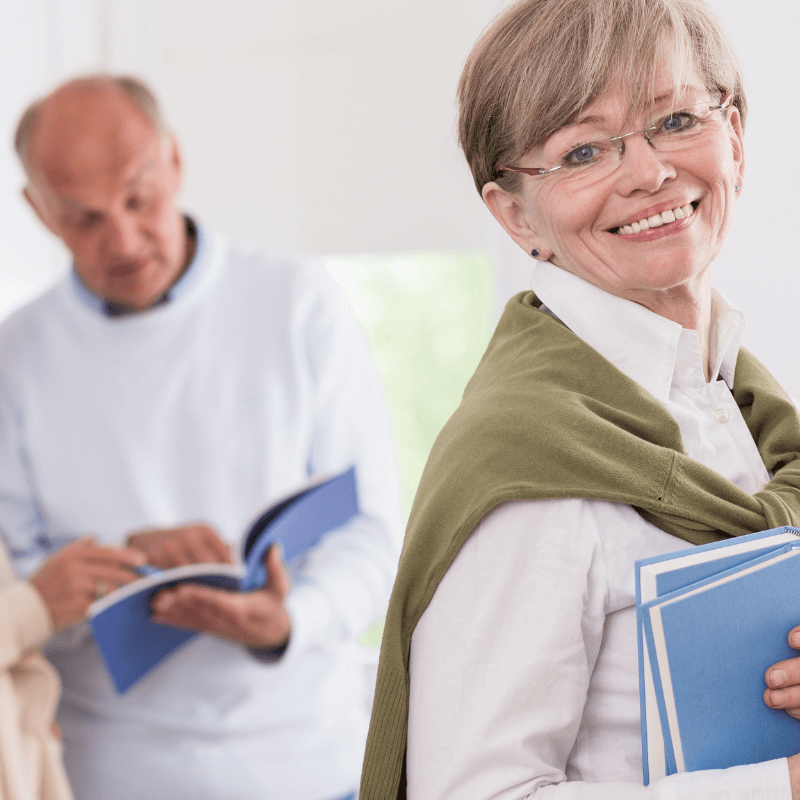 French student smiling and carrying books