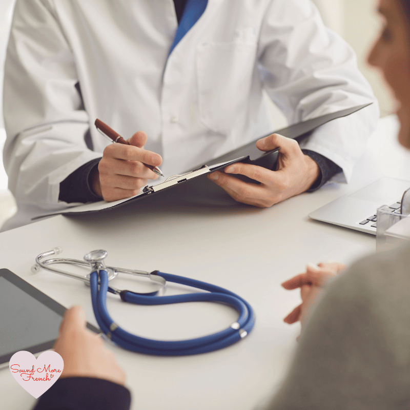 5 Close-up of a doctor taking notes during a consultation, with a stethoscope on the desk.