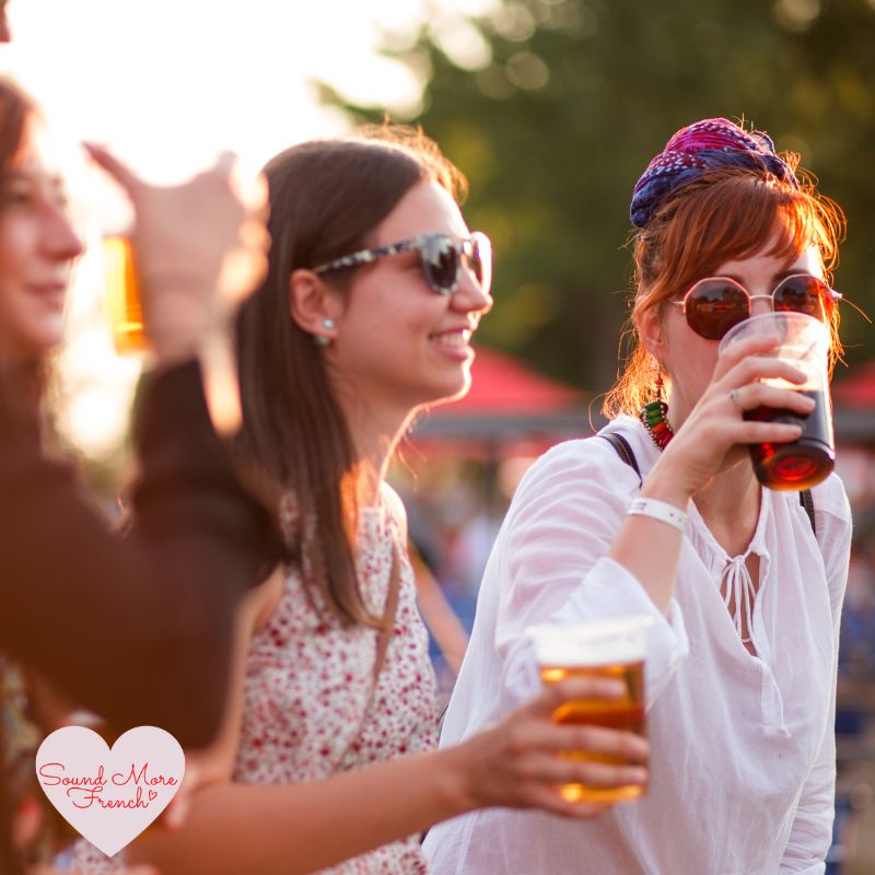 2 women_drinking_beer_outdoors_at_summer_festival