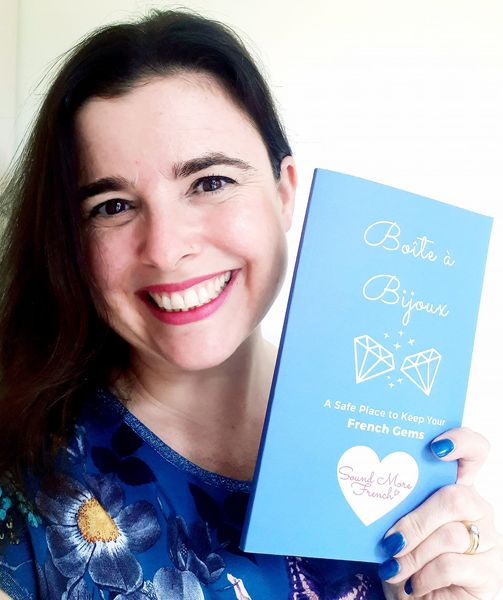 frannie_holding_a_copy_of_her_boite_a_bijoux_book_and_smiling