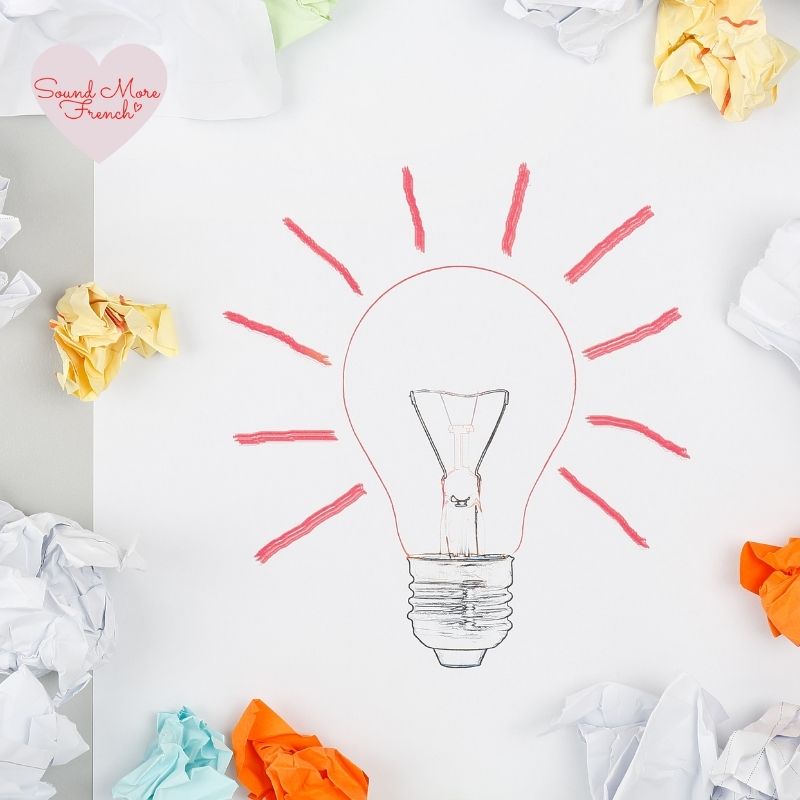 lightbulb_sketch_with_red_lines_on_white_paper_surrounded_by_coloured_crumpled_paper_sheets_with_sound_more_french_logo