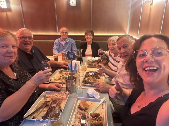 melt cambronne A_group_of_Café_Cats_in_Paris_enjoying_dinner_at_MELT-Cambronne_restaurant_with_platters_of_food_and_glasses_raised