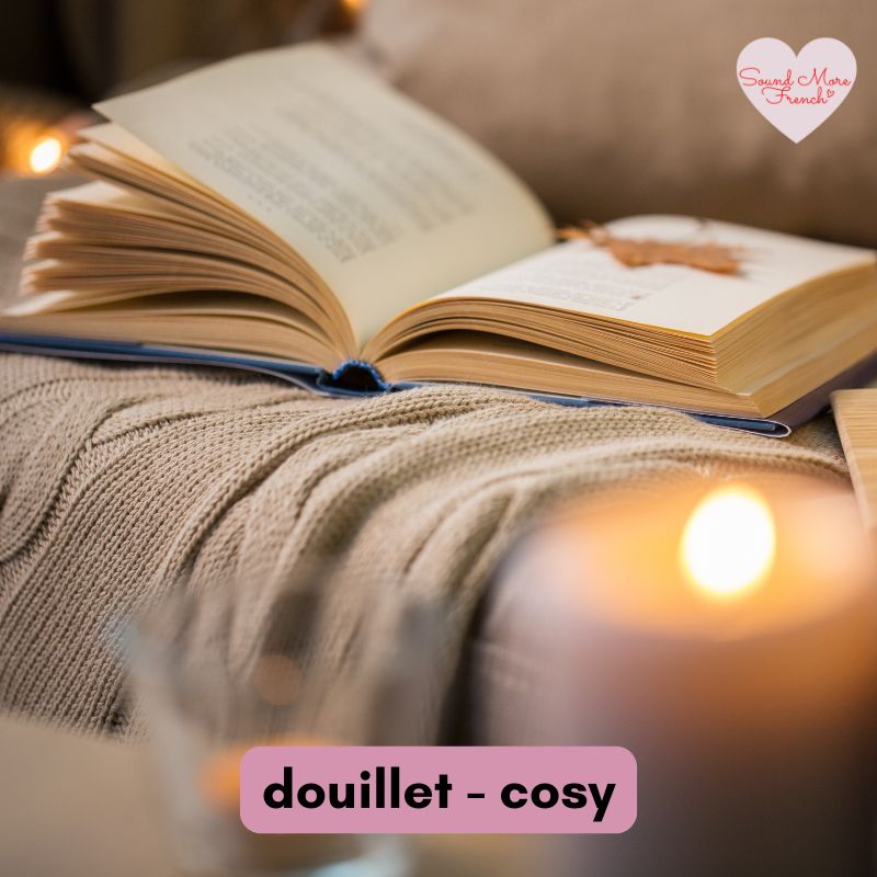 open_book_and_knitted_blanket_with_candle_light_creating_cosy_douillet_mood_sound_more_french_logo