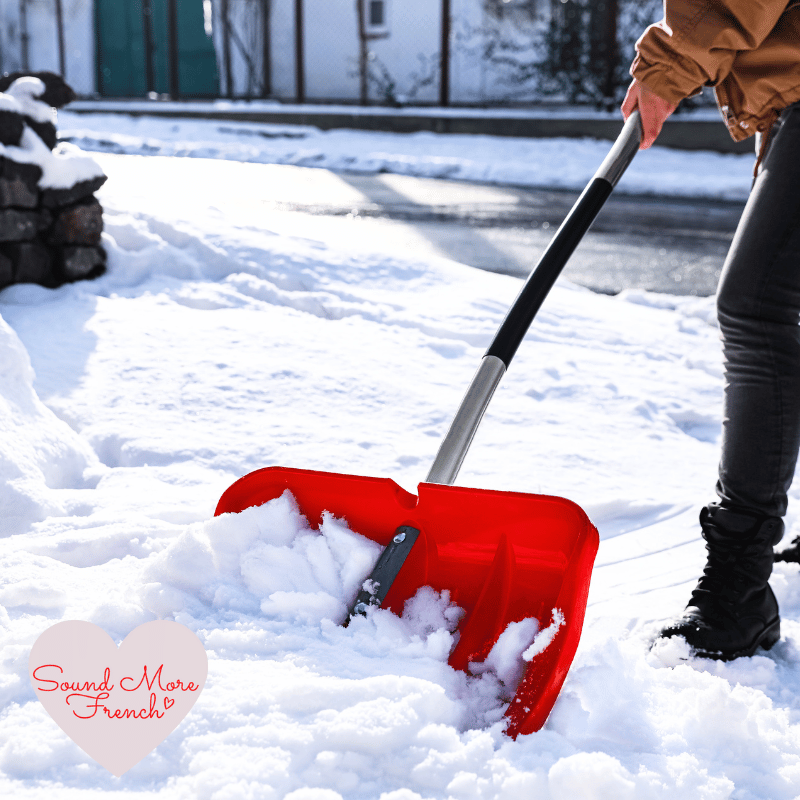 Person_shovelling_fresh_snow_with_a_red_snow_shovel_outside_on_a_bright_winter_day